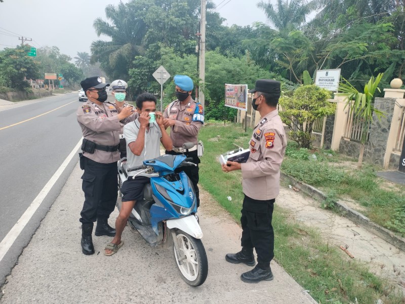 ANTISIPASI DAMPAK KABUT ASAP KARHUTLA, POLSEK BANDAR SEI KIJANG BAGI-BAGI MASKER DI JALINTIM